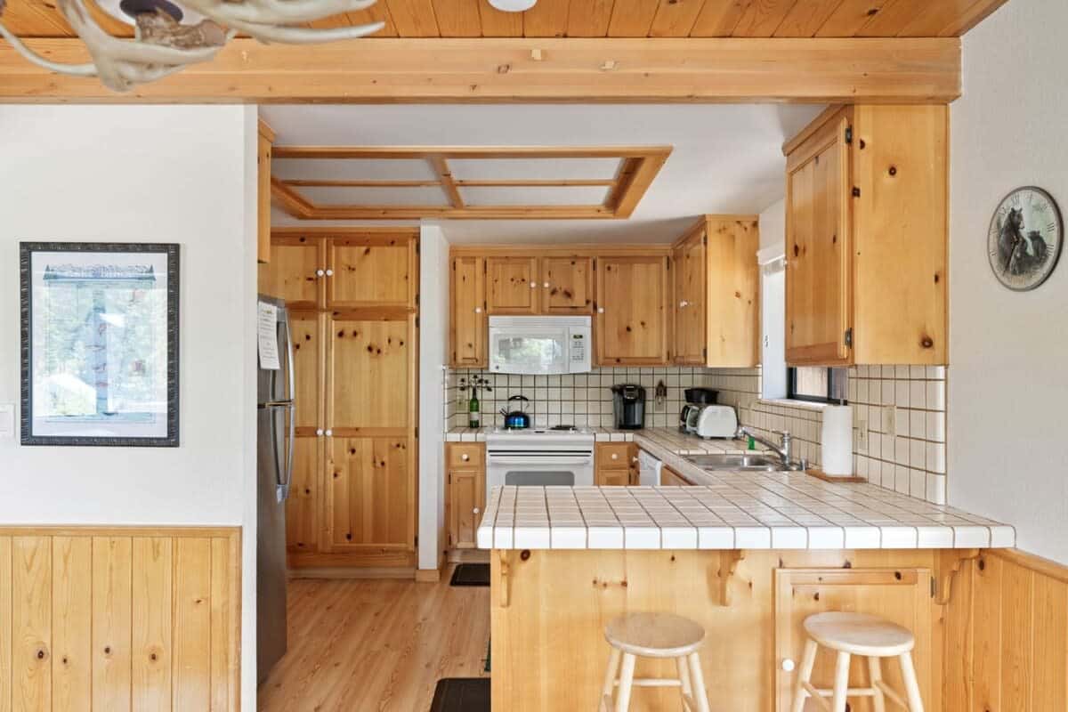 The kitchen boasts ample cabinet space, a spacious kitchen bar with seating for two, and basic cookware so you can easily whip up a delicious meal.