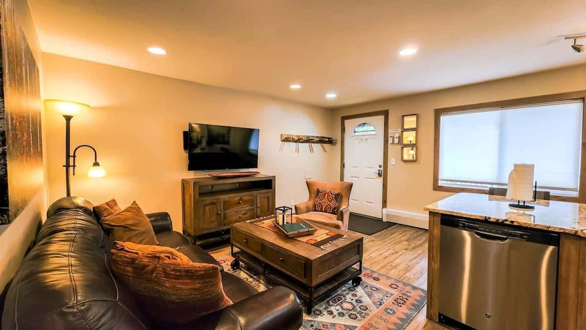 The cozy living area boasts a leather sofa, coffee table, armchair, a media console and a flat-screen TV. A row of hooks make it easy to unload your gear as you enter.