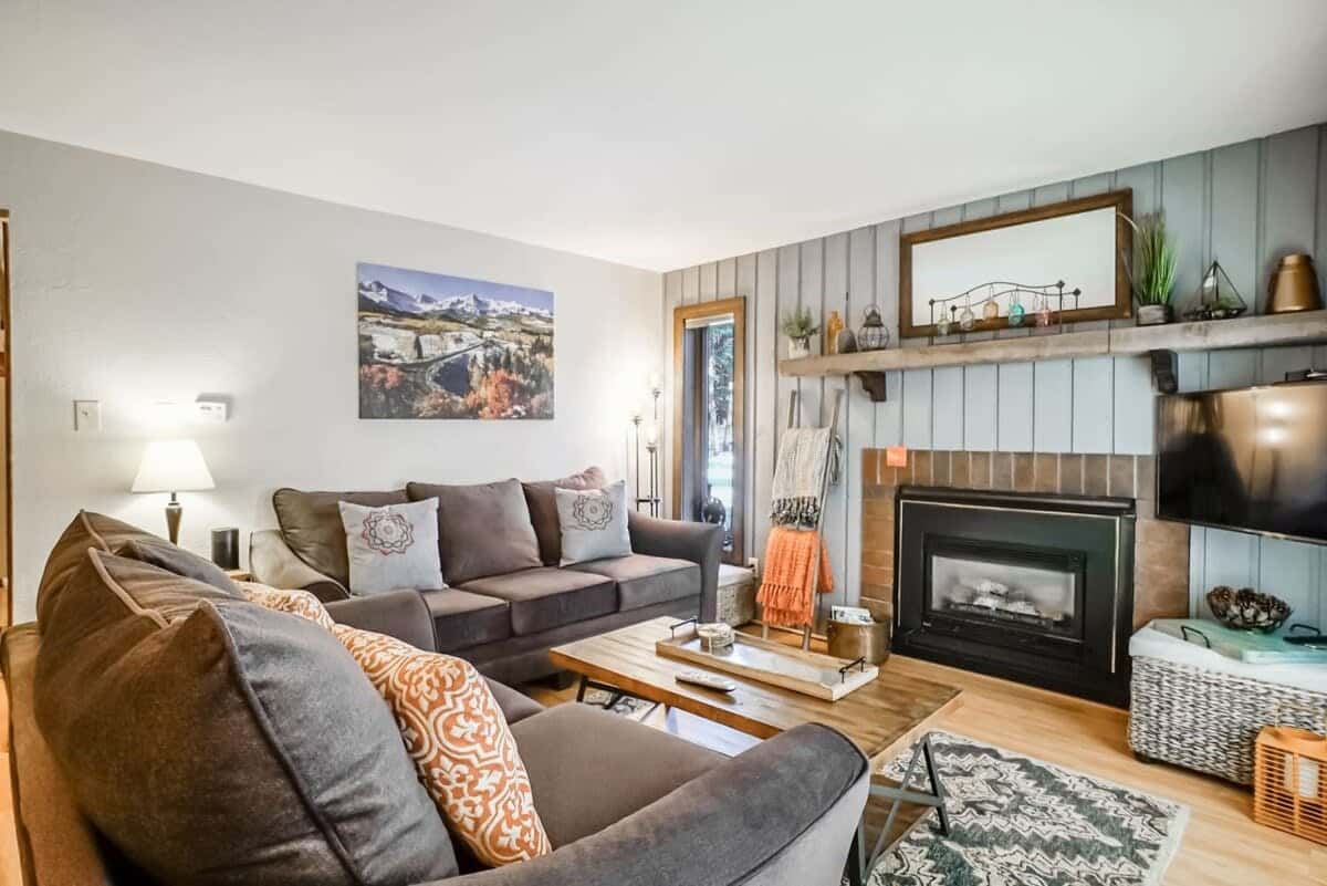 Relax in the cozy living room with a comfortable pullout sofa, indoor gas fireplace, and a flat-screen TV