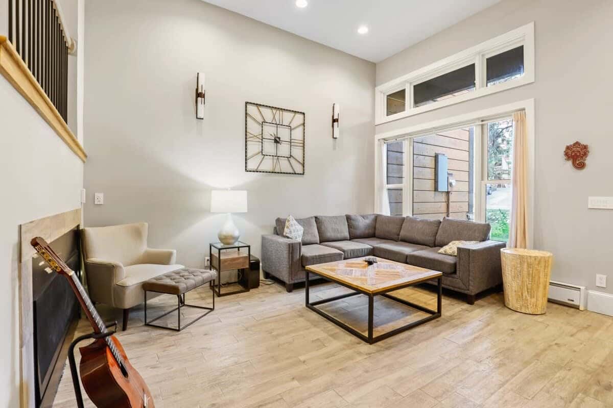 Relax in the living room with a comfortable sectional couch, cozy indoor gas fireplace, and flat-screen TV