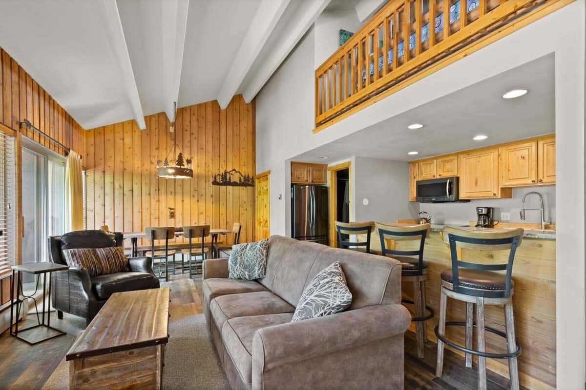 View of the family room, fully-equipped kitchen, and dining area