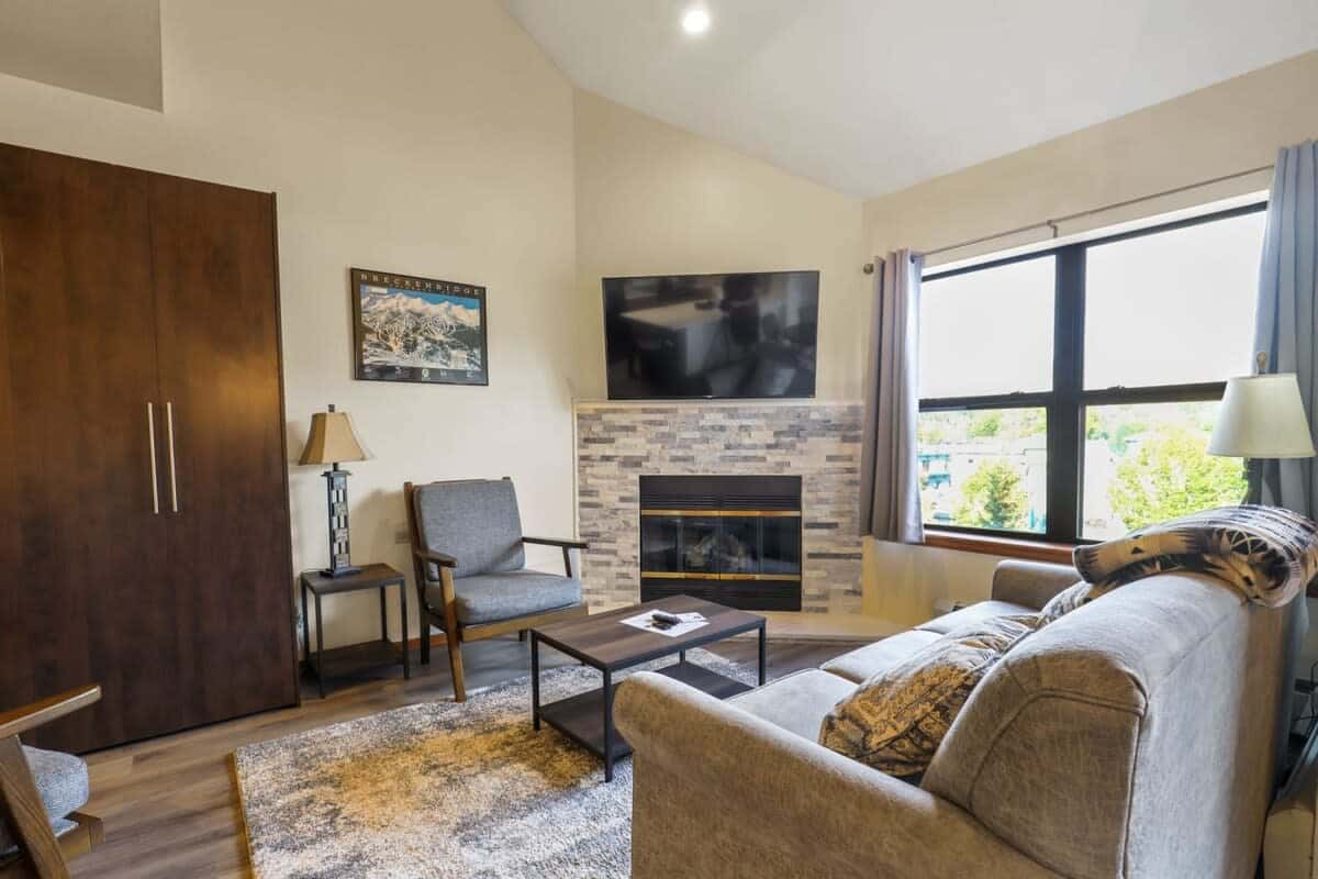 Relax in the family room with a plush sofa, armchair seating, a wood-burning fireplace with stone detail and a flat-screen TV. A full-size Murphy bed can be folded up with ease when not in use.