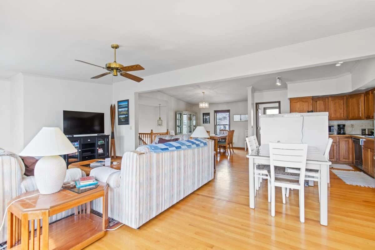 The view from the game table highlights the close proximity between the living, kitchen and dining areas in this bright and beautiful home.