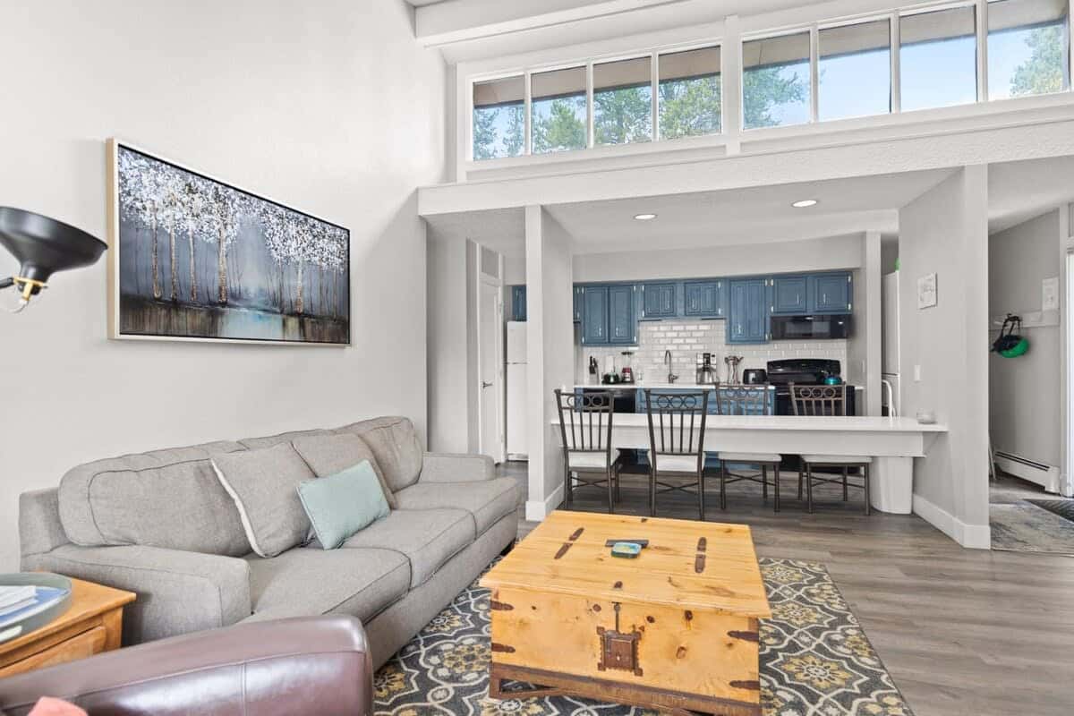 The open layout of this home, coupled with its abundant windows, make this a modern and inviting space. Skylights over the kitchen and dining area, with seating for four, brighten the nearby living area as well.