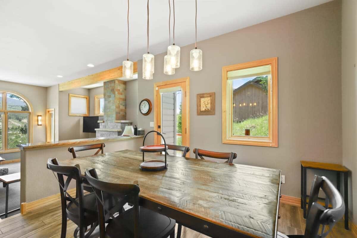 The view from the dining area highlights the close proximity between the living room and dining area and the open layout between the living, kitchen and dining spaces.