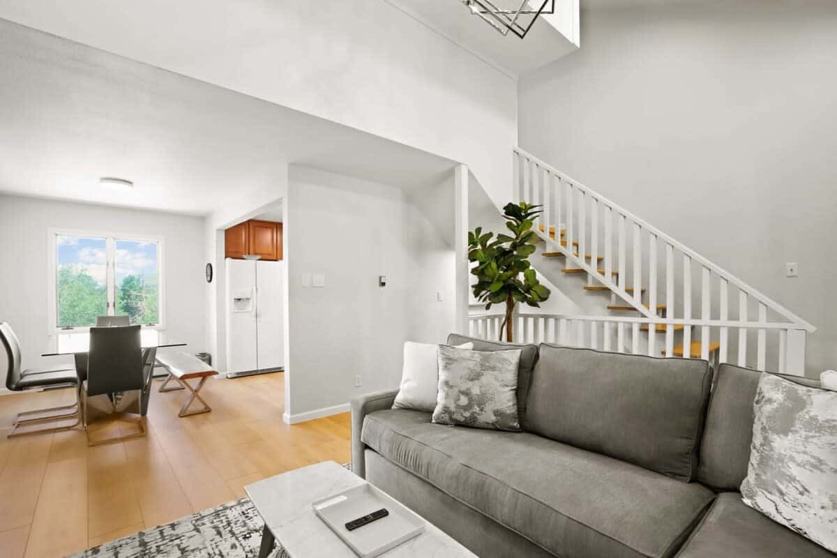 This angle highlights the convenient closeness of the living and dining areas, which has a lovely bay window for natural light and is adjacent to the kitchen.