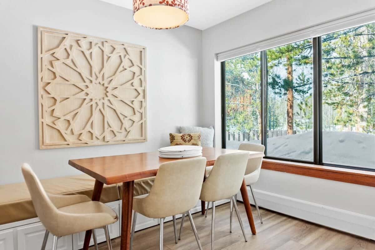 The light-filled dining room provides plenty of space for your entire group to enjoy a meal together while enjoying the view of the surrounding nature out the large window.