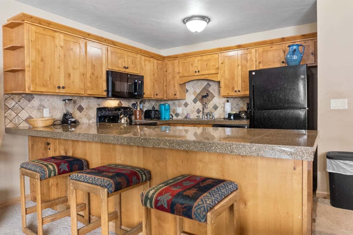 The spacious kitchen bar connects the fully equipped kitchen to the living room/dining area so you can easily stay connected from any room in the shared living space.