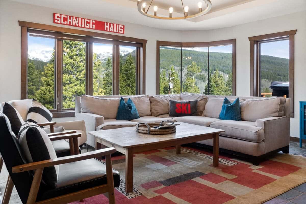The inviting living room provides plenty of space for your entire group to relax and large windows from all around showcasing the stunning views.