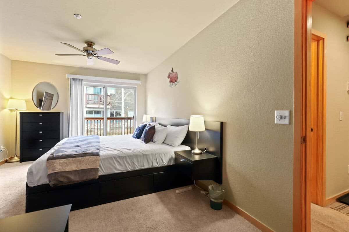 The spacious master bedroom includes a king-size bed, a 50” TV, a private balcony, and an en suite bathroom.