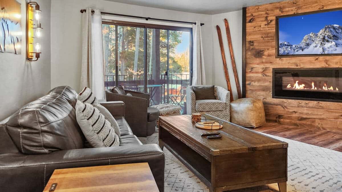 Relax in the stylish living room where you will find a mounted TV, a fireplace, and access to the private balcony.