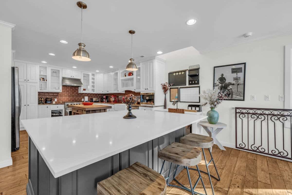 The spacious kitchen is fully equipped with top-of-the-line stainless steel appliances and includes a spacious kitchen island with seating for 3.