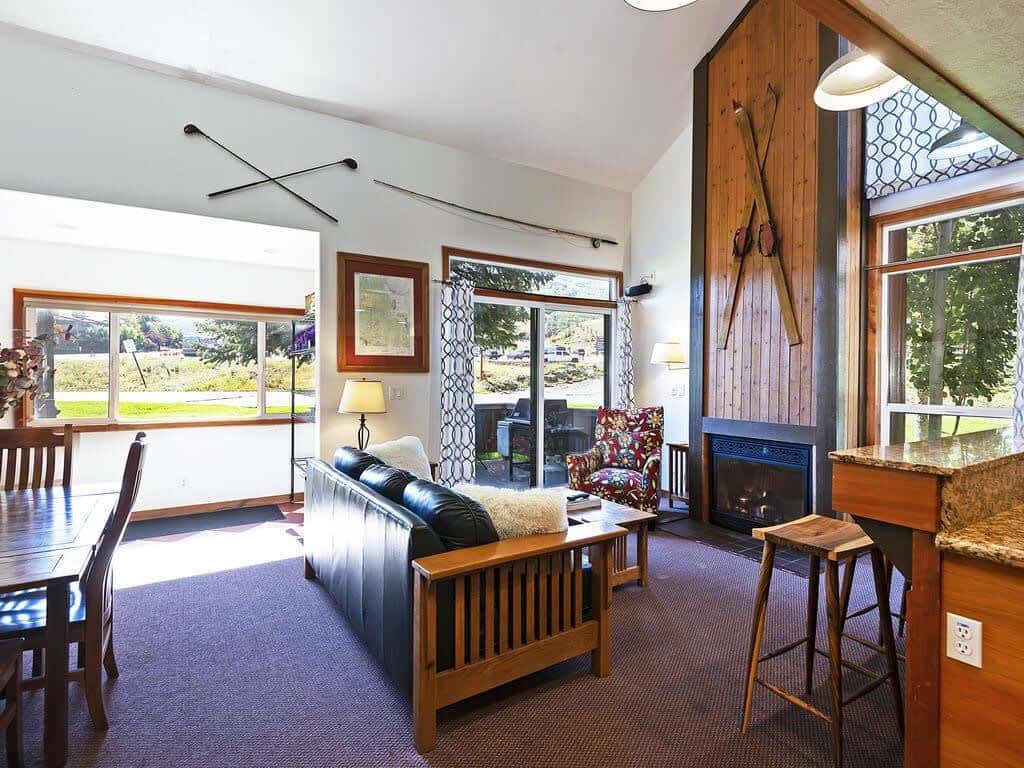 The open-concept living/dining/kitchen dining area makes it easy to stay connected whether you’re cooking, dining or relaxing. The living room features a leather couch, cozy armchair, fireplace and flat-screen TV.