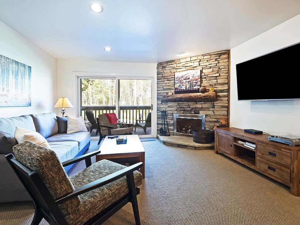 Relax in the family room with a plush sofa, armchair seating, a flat-screen TV, and an indoor fireplace