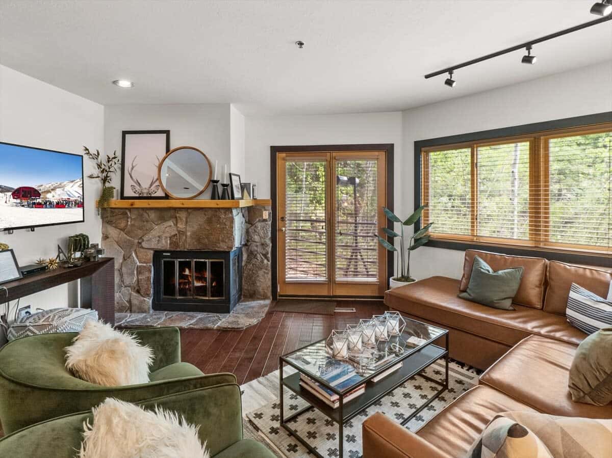 From the inviting living area with its luxurious leather sectional, plush armchairs, coffee table, stone fireplace and flat-screen TV, you can access the tranquil patio space with its private hot tub.