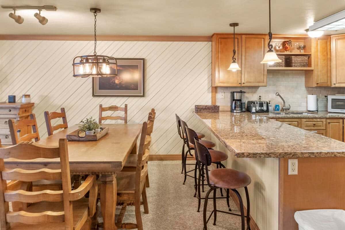 The charming dining area features a dining table with seats for six located right next to the kitchen bar where you will find additional seating for four providing ample space to enjoy mealtime with your group.