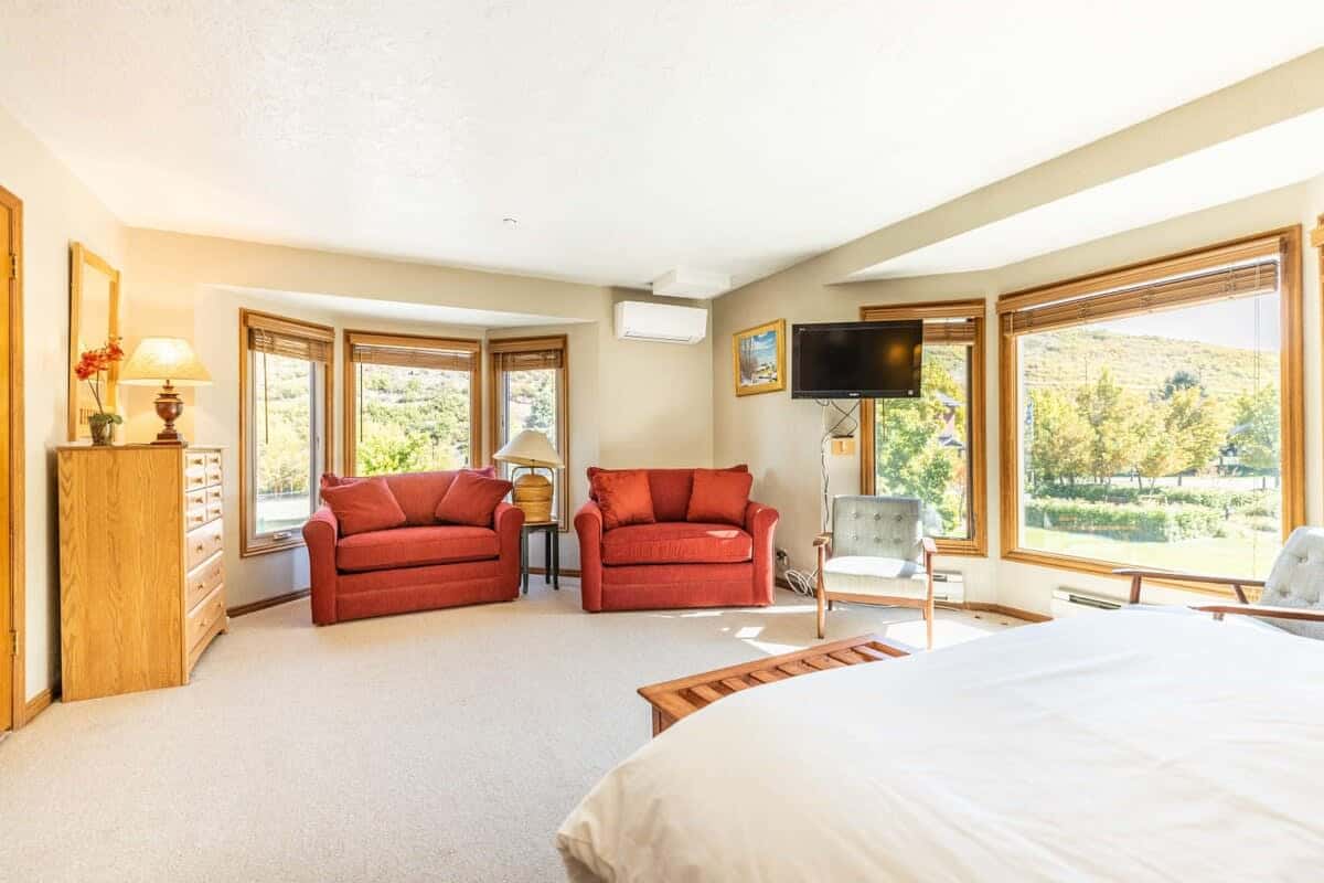 The spacious master bedroom boasts a lovely bay window flooding the room with natural light.
