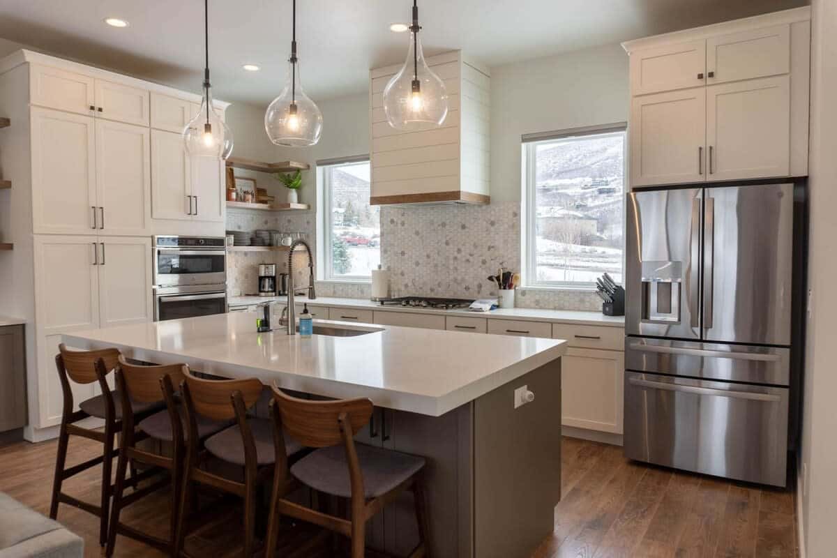 The modernly designed open living space features the living room, kitchen, and dining area and boasts beautiful hardwood floors, a stunning all-white kitchen, and a dining space flooded with natural light.