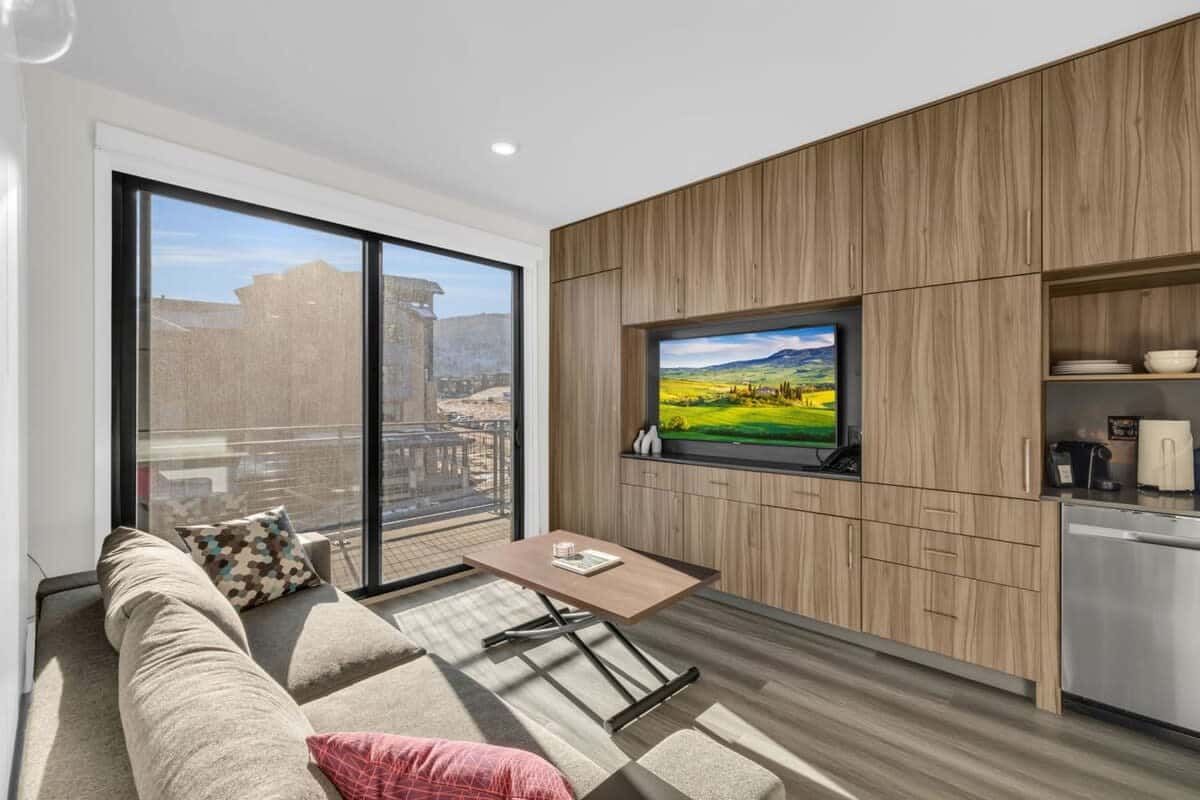 The dynamic living space can be used for a relaxing movie night before turning into a sleeping area with a pull-out queen bed and pull-out bunk beds.