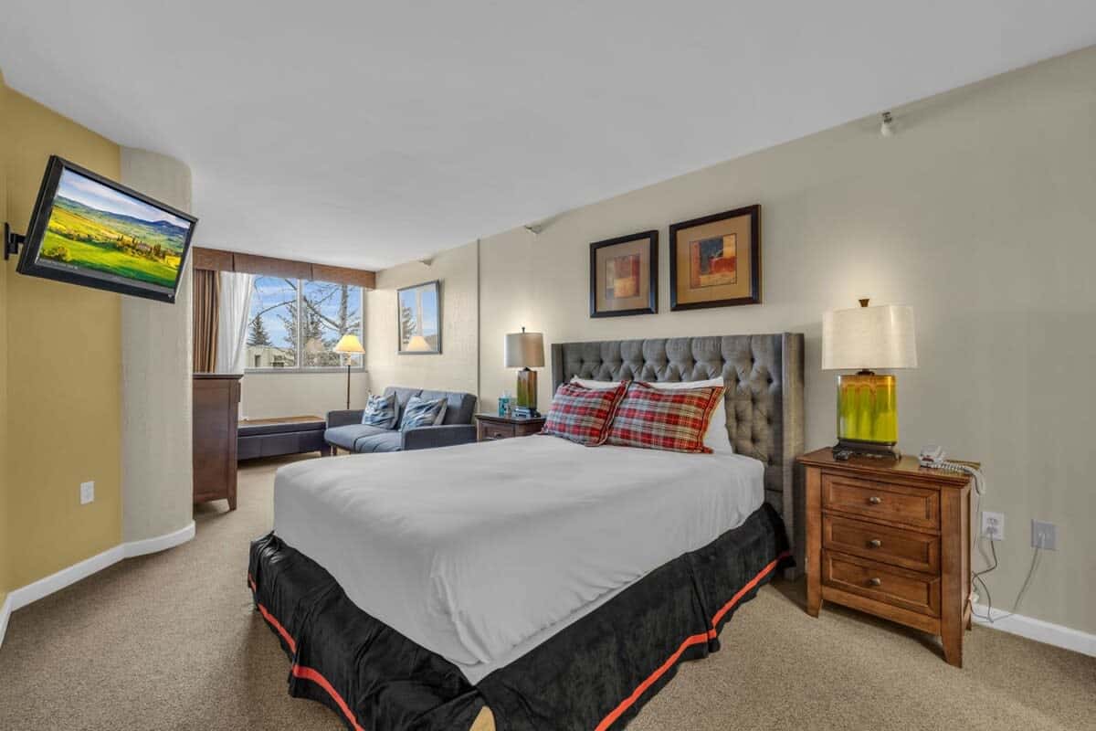 A bright and spacious bedroom provides a welcoming retreat to relax and recharge, outfitted with a queen-size bed and an attached bathroom.