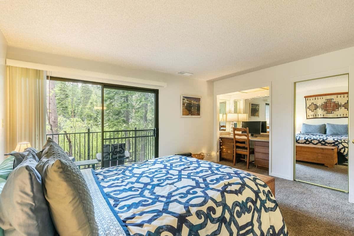 The spacious master bedroom has everything you need for a comfortable stay from a queen-size bed to a private balcony and en suite bathroom.