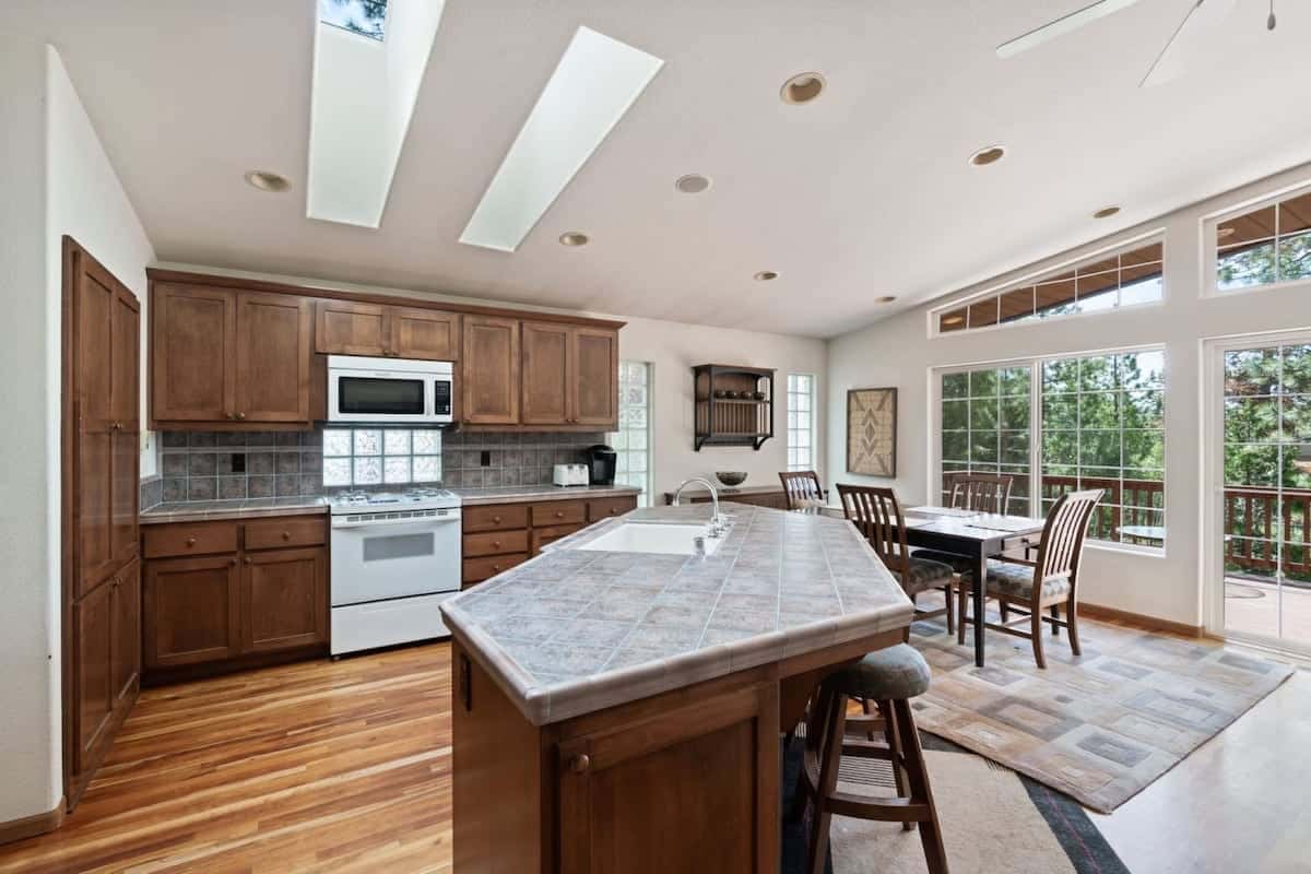 The spacious kitchen features a large kitchen island with 2 barstools, stainless steel appliances, and everything you need to cook a delicious meal for your group.