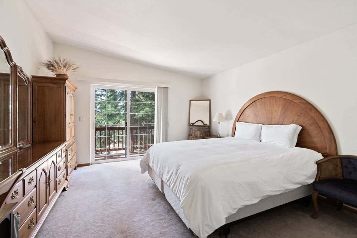 The master suite boasts a comfortable king-size bed, a large armoire and dresser, a desk, and an en suite bathroom.