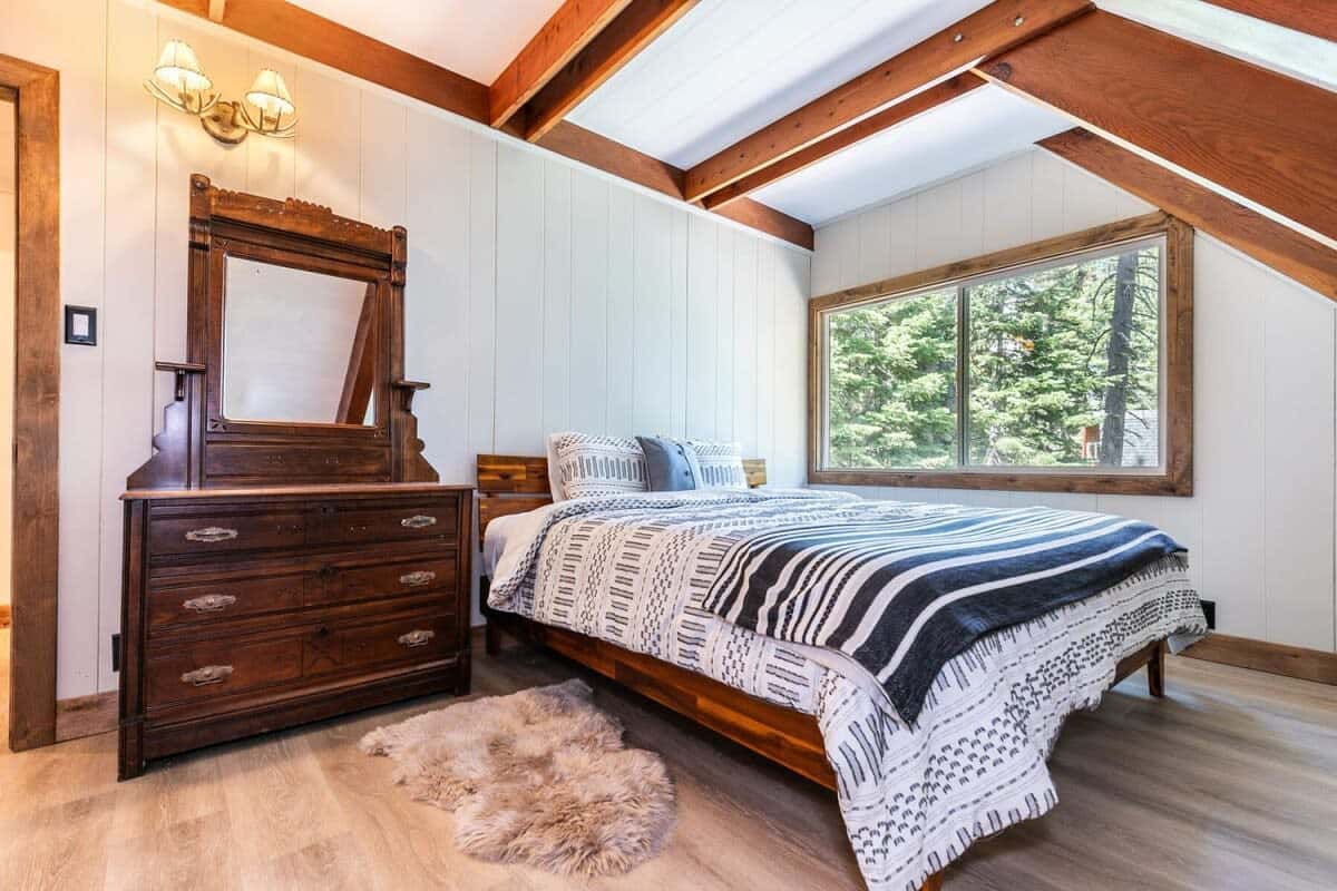Wake up to views over the surrounding trees from the king-size bed found in the first upstairs bedroom.