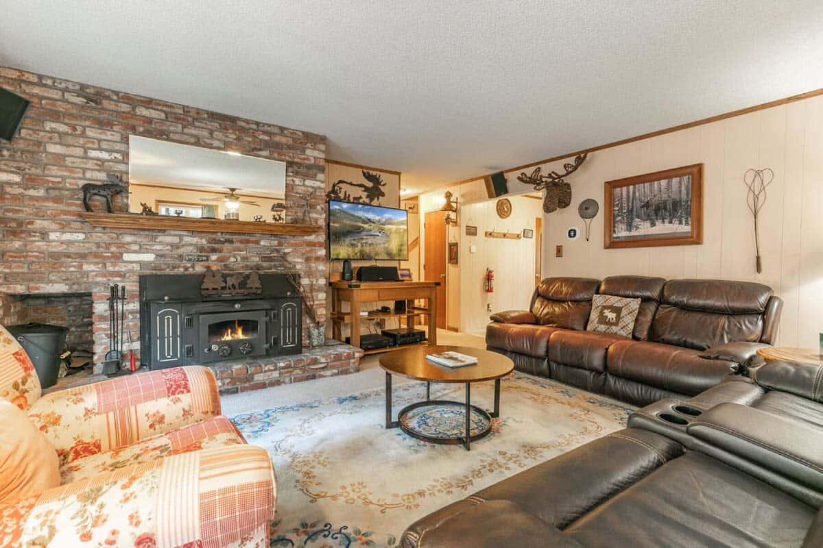 The cozy and inviting living room features plush furnishings for your group to curl up on while warming up by the wood-burning fireplace.