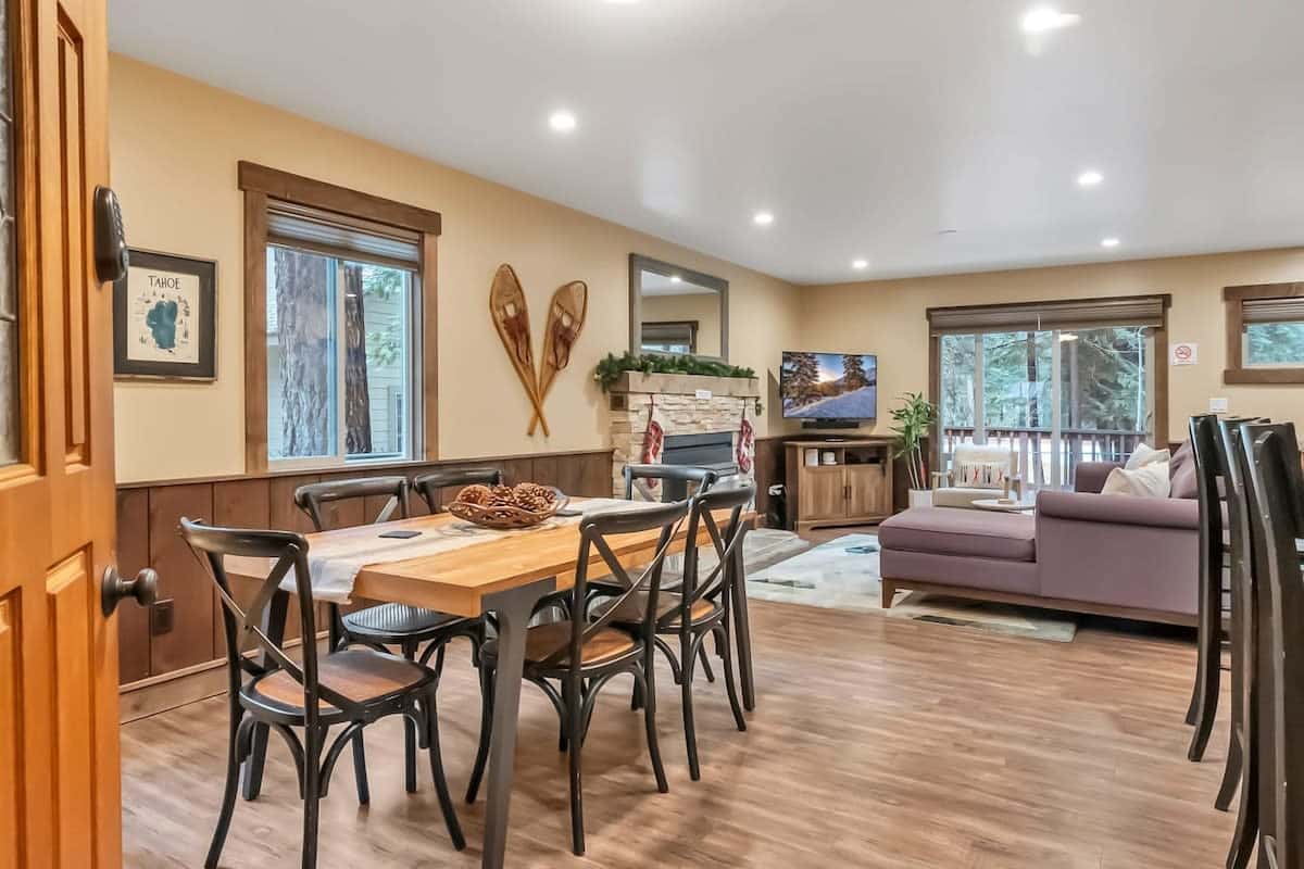 The main living space boasts an open and spacious layout with charming decor and windows all around filling the space with natural light.