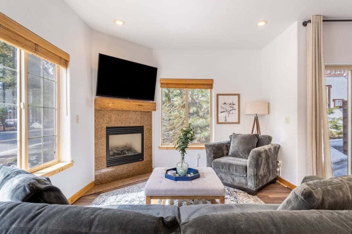 Sit back and relax in the cozy living room where you will find a plush sofa and a lounge chair situated around the fireplace.