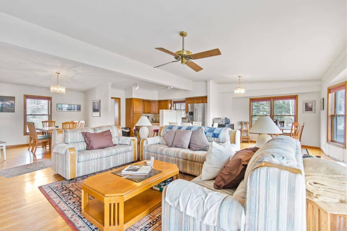 This bright and beautiful, open-concept living/kitchen/dining area offers up ample comfort with three couches, a coffee table, a flat-screen TV and plenty of puzzles and games for added fun.