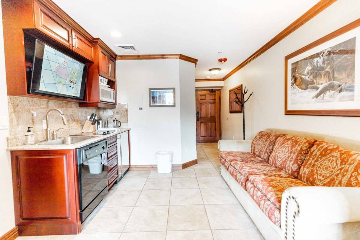 The home is an intimate and efficient space, with a well-laid-out kitchenette and living room, a spacious bathroom, and a comfortable bedroom.