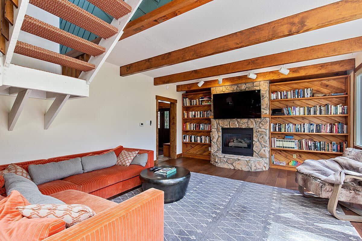 Family room with gas fireplace and mounted TV
