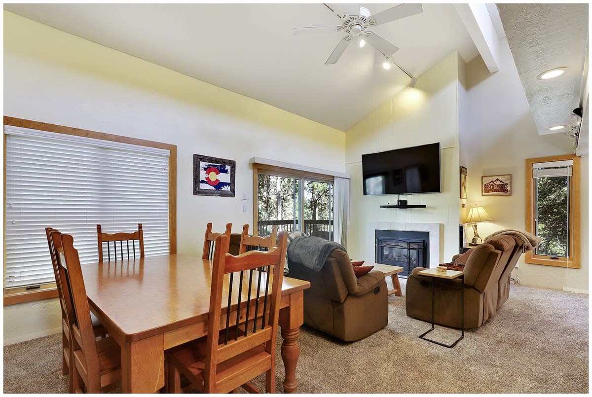 Living room with gas fireplace, mounted TV, and balcony