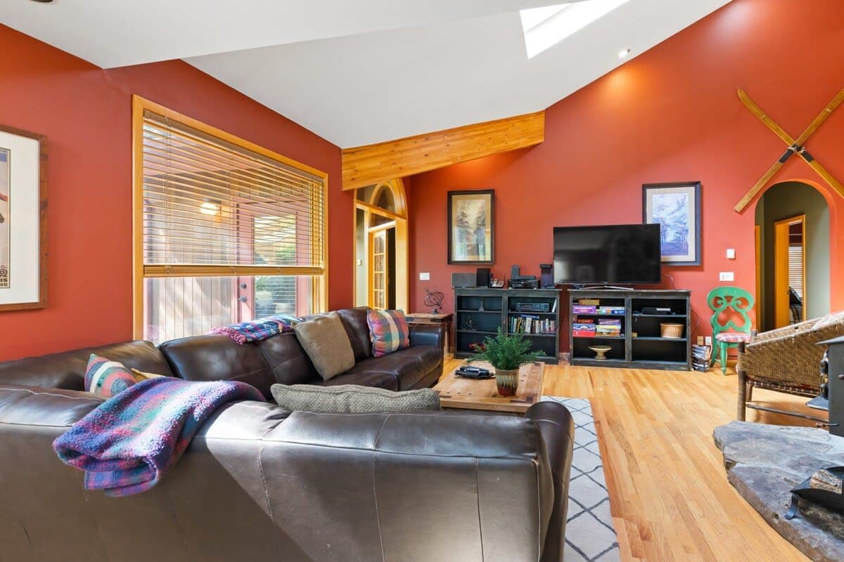 Living room: Smart TV with cable, wood-burning fireplace, electric baseboard heating, no A/C
