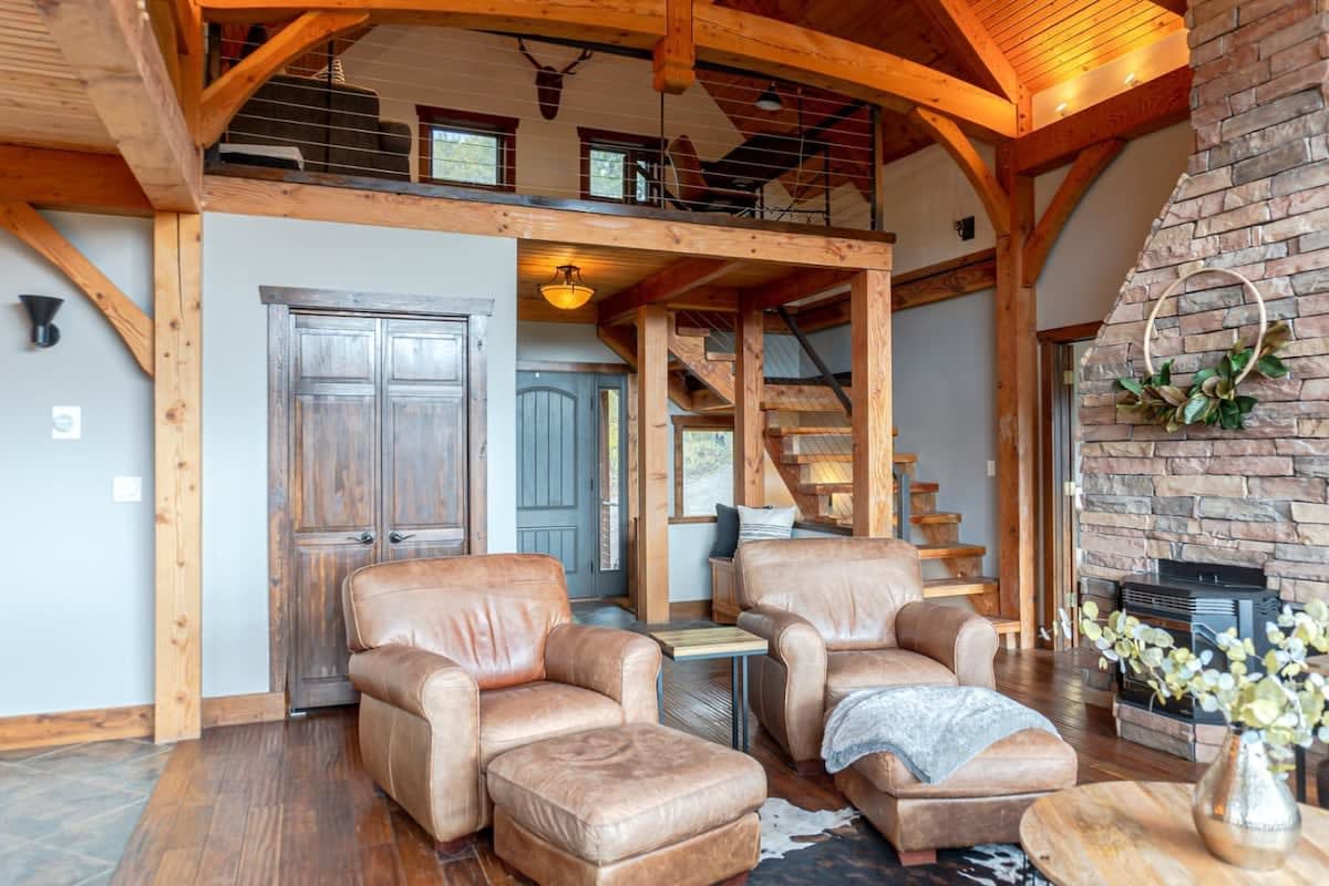 This luxurious custom home is full of character with exposed wood beams, soaring windows, and a bright open floor plan.