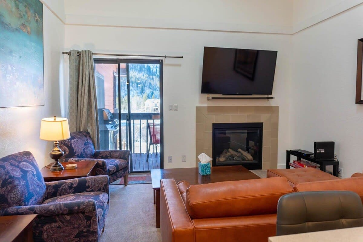 Warm up by the gas fireplace or enjoy a movie in the inviting living room where you will find a comfortable leather sofa and two reading chairs.