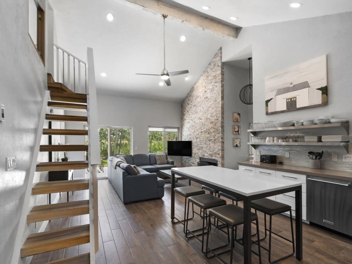 The stunning open-concept floor plan, vaulted ceilings and stone fireplace make an incredible impression as you enter this home. The dining table with seating for six is conveniently located in the kitchen for easy serving and dining.