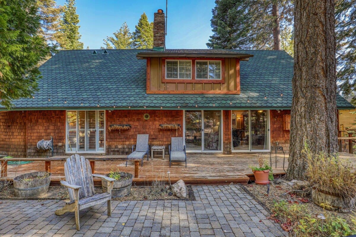 This 5-bedroom home is tucked among the trees in Carnelian Bay and features a fantastic fenced backyard with a hot tub.