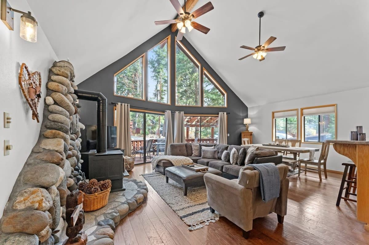 This charming three-bedroom, two-bathroom A-frame home offers a quintessential mountain retreat in Tahoe.